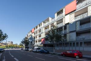 un immeuble situé sur le côté d'une rue dans l'établissement Bluemary - Spacieux T3 Garage balcon, à Lyon