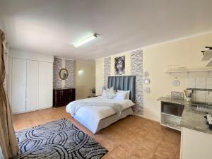 a bedroom with a white bed and a rug at MT Perry in Johannesburg