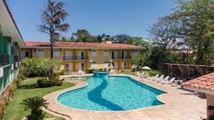 an image of a swimming pool in front of a house at Boulevard da Praia Flats in Porto Seguro