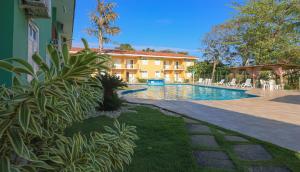 a swimming pool in front of a building at Boulevard Flats Mare Mansa in Porto Seguro +9 photos