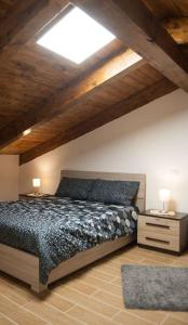 a bedroom with a large bed and a skylight at IL Casale Di Gio in Naples