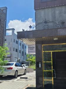 a white car parked in front of a building at TreehouseUnseo GuestHouse in Incheon