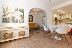a dining room and living room with a table and chairs at 228 Lovely Home La Zenia - Alicante Holiday in Playa Flamenca