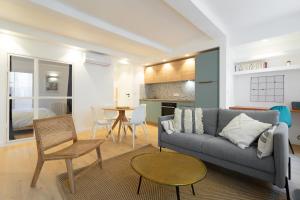 ein Wohnzimmer mit einem Sofa und einem Tisch in der Unterkunft T3 ** BALCON ** VIEUX PORT ** CENTRE in Marseille