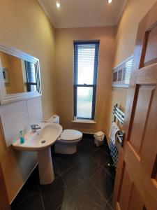 a bathroom with a white toilet and a sink at St Ives in Halifax