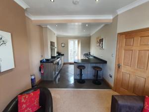 a kitchen with a counter and a bar in a room at St Ives in Halifax