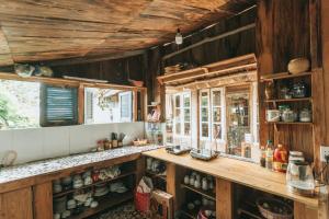 a kitchen with wooden walls and a counter and a window at Tiệm Cà Phê Mer Homestay & Coffee Mộc Châu in Mộc Châu
