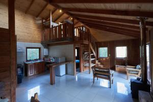 a large kitchen with wooden walls and a wooden ceiling at Entre Pampa y Bosque in Villarrica