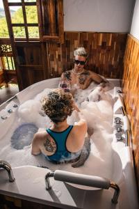 two people in a bath tub with wine glasses at Hotel Santa Laura in Jericó