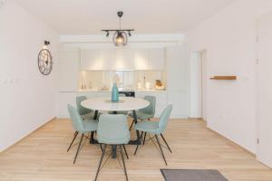 a dining room with a table and chairs at Bliss on the Bay in Njivice