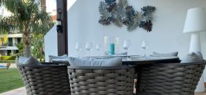 a dining table with wine glasses on a patio at Vila Sol, Apartment 468 in Quarteira