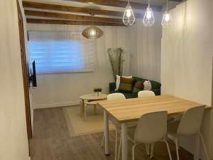 a living room with a table and chairs and a couch at Teide Hideaway in Vilaflor +9 photos