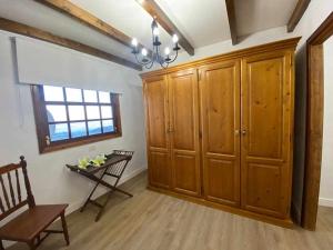 a room with wooden cabinets and a chair and a window at Teide Hideaway in Vilaflor