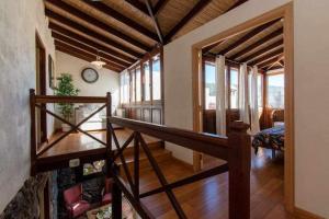 a room with a staircase with a clock on the wall at Vilaflor La casita de campo in Vilaflor