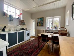 a kitchen with a table and a sink and a stove at Artist's Retreat - Old Signal Box - Private Sauna in Bath