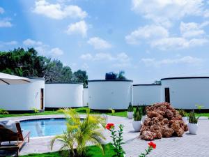 a backyard with a swimming pool and a resort at homeland bro in Dar es Salaam