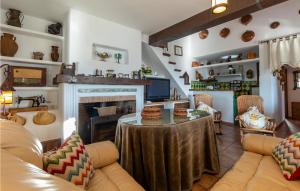 a living room with a table and a fireplace at Cozy Home In Iznajar With Swimming Pool in Iznájar