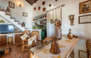 a kitchen and living room with a table and chairs at Cozy Home In Iznajar With Swimming Pool in Iznájar