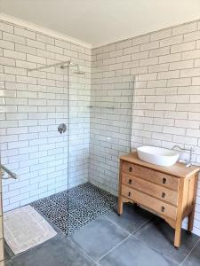 a bathroom with a sink and a glass shower at 5 Clifton Road in Nottingham Road