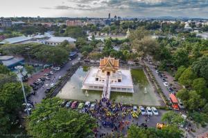 an overhead view of a crowd of people standing in front of a temple at บ้านคุณย่า in Rayong