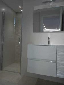 bagno con doccia, lavandino e specchio di Villa Infinity Vistas Wiffi y jacuzzi ad Adeje