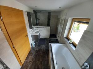 a bathroom with a tub and a toilet and a sink at Ferienwohnung Bergtroll in Uderns +33 photos