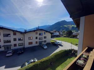 a view of a building with cars parked in a parking lot at Ferienwohnung Bergtroll in Uderns
