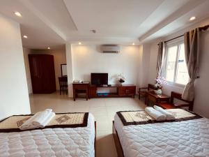 een slaapkamer met 2 bedden en een woonkamer bij SaiGon Europe Hotel in Ho Chi Minh-stad