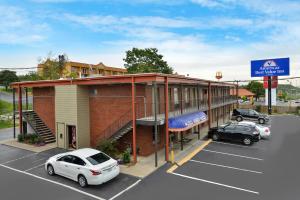 a building with cars parked in a parking lot at Americas Best Value Inn Near Downtown Nashville in Nashville