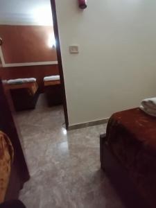 Postel nebo postele na pokoji v ubytování New Saint Catherine Hotel
