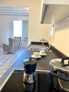 a kitchen with a coffee maker on a counter at Dimore San Giovanni - Puglia Mia Apartments in Monopoli +22 photos