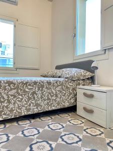 a bedroom with a bed and a dresser and a window at Dimore San Giovanni - Puglia Mia Apartments in Monopoli