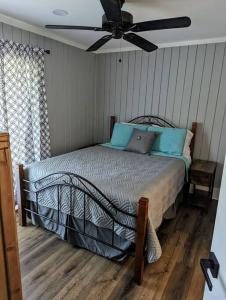a bedroom with a bed with a ceiling fan at Captains Hideaway in Salem