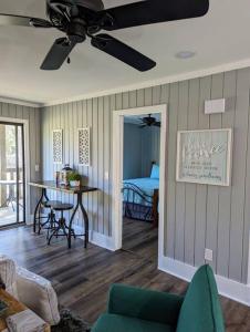 a living room with a ceiling fan and a table at Captains Hideaway in Salem