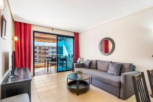 a living room with a couch and a table at Bright and welcoming holiday home in Puerto de Santiago