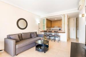 a living room with a couch and a table at Bright and welcoming holiday home in Puerto de Santiago