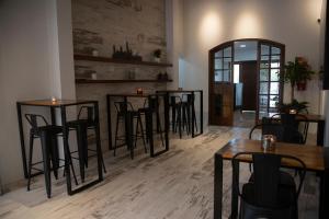 a bar with stools and tables in a room at Rozas Apart in Ezeiza