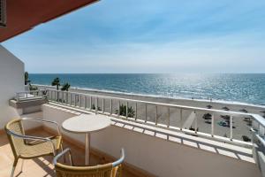 a balcony with a table and chairs and the ocean at Rincón Sol in Rincón de la Victoria