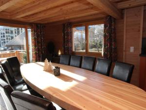 a dining room table with a cat sitting on top of it at Chalet La Toussuire, 6 pièces, 14 personnes - FR-1-417-6 in La Toussuire