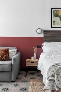 a bedroom with a bed and a couch at Bob W Madrid Atocha in Madrid