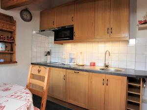 a kitchen with wooden cabinets and a sink at Appartement La Toussuire, 3 pièces, 4 personnes - FR-1-417-67 in La Toussuire
