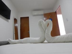 Un pat sau paturi într-o cameră la Pousada Ah Mar