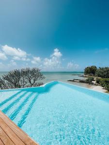 a swimming pool with a view of the ocean at BEACH VILLA ROCCA in Grand Gaube
