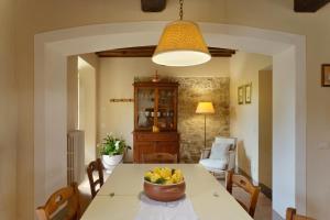a kitchen with a table with a bowl of fruit on it at Borgo Casalvento in Cantagrillo