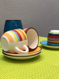 a cup on a plate on a table at Domus Alice in Monserrato