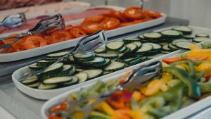a buffet with cucumbers and pretzels and other foods at Good Morning City Copenhagen Star in Copenhagen