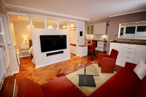 a living room with a large flat screen tv at Seepferdchen Suite in Timmendorfer Strand