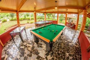 a room with a pool table in a house at Hotel Fazenda Vale Alvorada in Cascavel