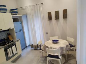 a kitchen with a table and chairs in a kitchen at Cubo Apartments in Vico Equense