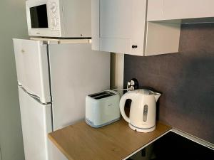 a kitchen with a refrigerator and a toaster on a counter at Spacious Apartment in Old Town in Viljandi